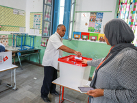 A Tunisian man casts his ballot at a polling station during the presidential election in Ariana, a suburb of Tunis, Tunisia, on October 6, 2...