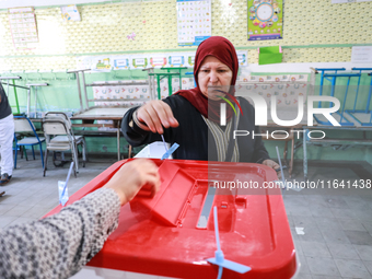 A Tunisian woman casts her ballot at a polling station during the presidential election in Ariana, a suburb of Tunis, Tunisia, on October 6,...