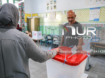 A Tunisian man casts his ballot at a polling station during the presidential election in Ariana, a suburb of Tunis, Tunisia, on October 6, 2...