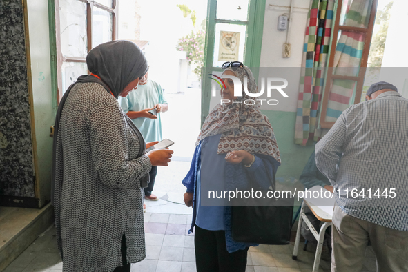 An election official saves a voter's data via a smartphone application from the Independent High Authority for Elections (ISIE). Tunisians g...