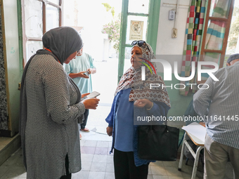 An election official saves a voter's data via a smartphone application from the Independent High Authority for Elections (ISIE). Tunisians g...