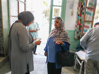 An election official saves a voter's data via a smartphone application from the Independent High Authority for Elections (ISIE). Tunisians g...