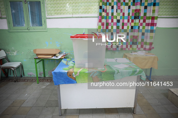 An almost empty ballot box is seen in a polling station during the presidential election in Ariana, a suburb of Tunis, Tunisia, on October 6...