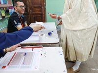 A Tunisian elderly man has his finger inked as he prepares to cast his vote at a polling station during the presidential election in Ariana,...