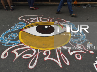 A person walks next to the protest site where the junior doctors hold a hunger strike to protest against the rape and murder of a PGT woman...