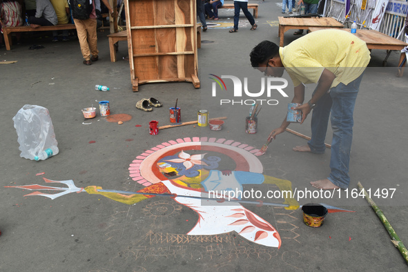 A person paints on the street at the protest site where the junior doctors hold a hunger strike to protest against the rape and murder of a...