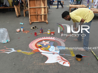 A person paints on the street at the protest site where the junior doctors hold a hunger strike to protest against the rape and murder of a...