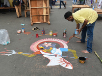 A person paints on the street at the protest site where the junior doctors hold a hunger strike to protest against the rape and murder of a...