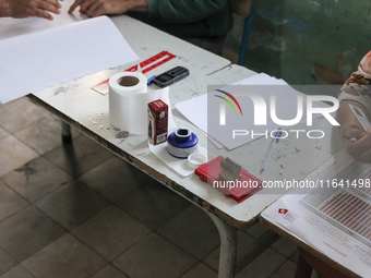 A bottle of indelible ink for election purposes is seen at a polling station during the presidential election in Ariana, a suburb of Tunis,...