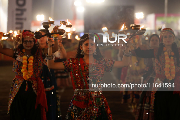 Participants perform 'Garba' during the Dainik Bhaskar Abhivyakti 'Garba Mahotsav' on the occasion of the 'Navratri festival' in Jaipur, Raj...