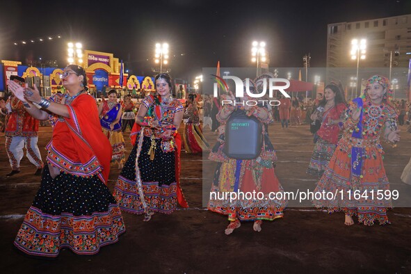 Participants perform 'Garba' during the Dainik Bhaskar Abhivyakti 'Garba Mahotsav' on the occasion of the 'Navratri festival' in Jaipur, Raj...