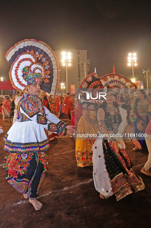 Participants perform 'Garba' during the Dainik Bhaskar Abhivyakti 'Garba Mahotsav' on the occasion of the 'Navratri festival' in Jaipur, Raj...