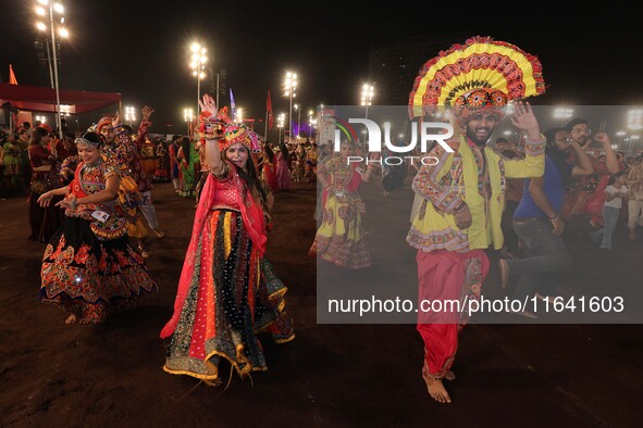 Participants perform 'Garba' during the Dainik Bhaskar Abhivyakti 'Garba Mahotsav' on the occasion of the 'Navratri festival' in Jaipur, Raj...