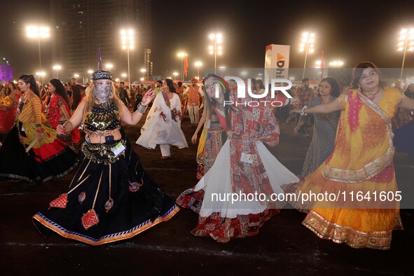 Participants perform 'Garba' during the Dainik Bhaskar Abhivyakti 'Garba Mahotsav' on the occasion of the 'Navratri festival' in Jaipur, Raj...