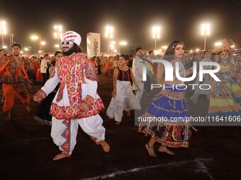 Participants perform 'Garba' during the Dainik Bhaskar Abhivyakti 'Garba Mahotsav' on the occasion of the 'Navratri festival' in Jaipur, Raj...