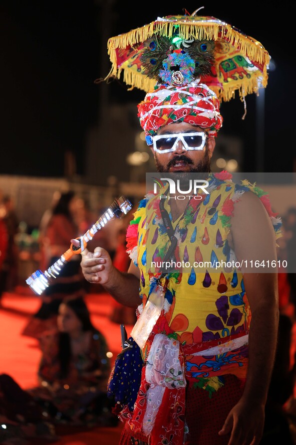 A participant takes part in the Dainik Bhaskar Abhivyakti 'Garba Mahotsav' during the 'Navratri festival' in Jaipur, Rajasthan, India, on Oc...