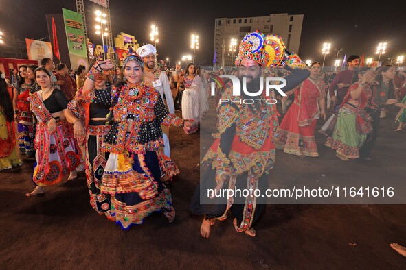 Participants perform 'Garba' during the Dainik Bhaskar Abhivyakti 'Garba Mahotsav' on the occasion of the 'Navratri festival' in Jaipur, Raj...