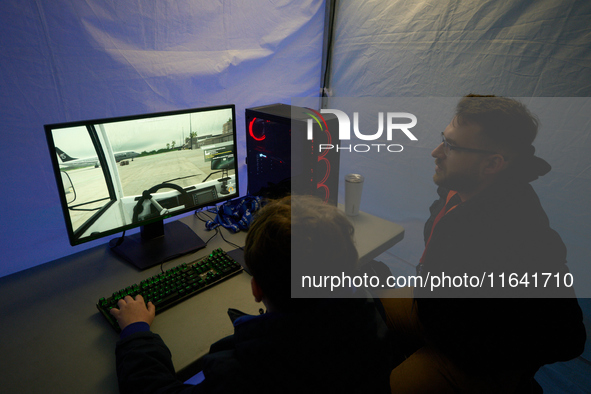 A visitor plays a pushback tractor simulator at the Warsaw Institute of Aviation in Warsaw, Poland on 04 October, 2024. The annual Aviation...