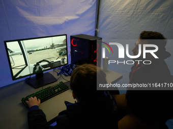 A visitor plays a pushback tractor simulator at the Warsaw Institute of Aviation in Warsaw, Poland on 04 October, 2024. The annual Aviation...