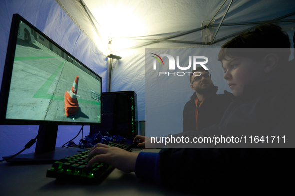 A visitor plays a pushback tractor simulator at the Warsaw Institute of Aviation in Warsaw, Poland on 04 October, 2024. The annual Aviation...