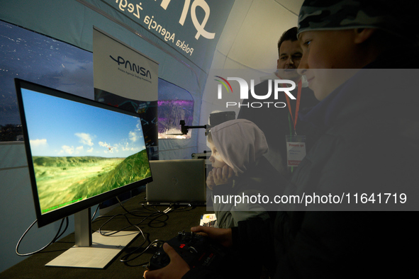 A visitor plays a flight simulator at the Warsaw Institute of Aviation in Warsaw, Poland on 04 October, 2024. The annual Aviation Night is a...