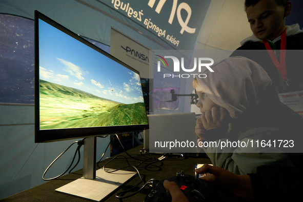 A visitor plays a flight simulator at the Warsaw Institute of Aviation in Warsaw, Poland on 04 October, 2024. The annual Aviation Night is a...