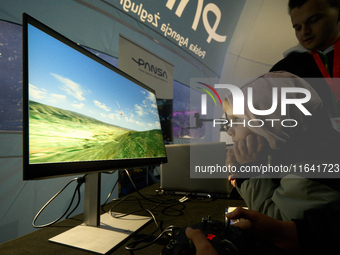 A visitor plays a flight simulator at the Warsaw Institute of Aviation in Warsaw, Poland on 04 October, 2024. The annual Aviation Night is a...