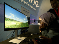 A visitor plays a flight simulator at the Warsaw Institute of Aviation in Warsaw, Poland on 04 October, 2024. The annual Aviation Night is a...