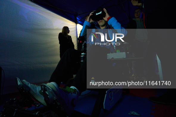 A visitor flies a fighter jet simulator at the Warsaw Institute of Aviation in Warsaw, Poland on 04 October, 2024. The annual Aviation Night...