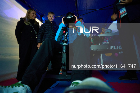 A visitor flies a fighter jet simulator at the Warsaw Institute of Aviation in Warsaw, Poland on 04 October, 2024. The annual Aviation Night...