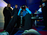 A visitor flies a fighter jet simulator at the Warsaw Institute of Aviation in Warsaw, Poland on 04 October, 2024. The annual Aviation Night...