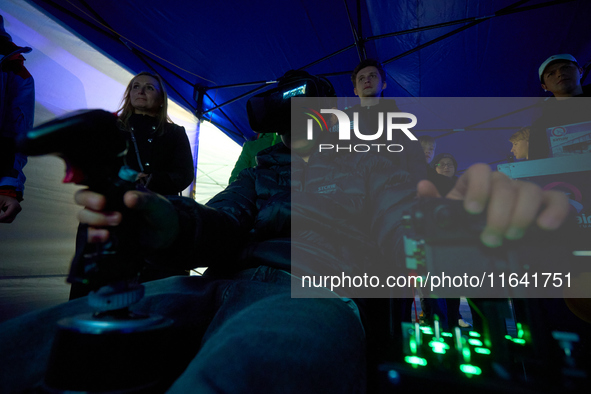 A visitor flies a fighter jet simulator at the Warsaw Institute of Aviation in Warsaw, Poland on 04 October, 2024. The annual Aviation Night...