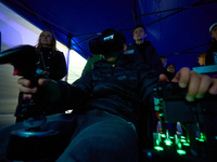 A visitor flies a fighter jet simulator at the Warsaw Institute of Aviation in Warsaw, Poland on 04 October, 2024. The annual Aviation Night...