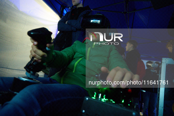 A visitor flies a fighter jet simulator at the Warsaw Institute of Aviation in Warsaw, Poland on 04 October, 2024. The annual Aviation Night...