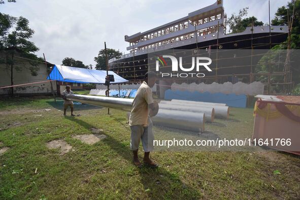 Workers make a Titanic ship as a pandal for the Durga Puja festival in Nagaon District, Assam, India, on October 6, 2024. 