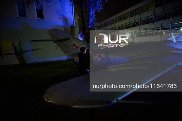 Visitors observe an old fighter jet at the Warsaw Institute of Aviation in Warsaw, Poland on 04 October, 2024. The annual Aviation Night is...