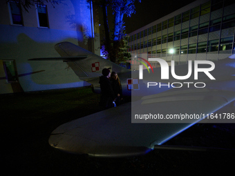 Visitors observe an old fighter jet at the Warsaw Institute of Aviation in Warsaw, Poland on 04 October, 2024. The annual Aviation Night is...