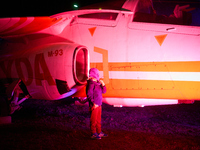 A child pulls his hat over his face while posing for a photo at the Warsaw Institute of Aviation in Warsaw, Poland on 04 October, 2024. The...