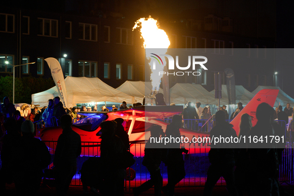 Flames from a hot air balloon burner rise above a parked Tecnam P2008JC MkII at the Warsaw Institute of Aviation in Warsaw, Poland on 04 Oct...