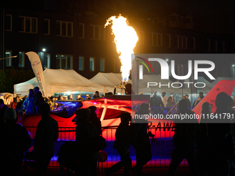 Flames from a hot air balloon burner rise above a parked Tecnam P2008JC MkII at the Warsaw Institute of Aviation in Warsaw, Poland on 04 Oct...