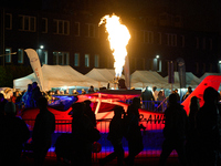 Flames from a hot air balloon burner rise above a parked Tecnam P2008JC MkII at the Warsaw Institute of Aviation in Warsaw, Poland on 04 Oct...