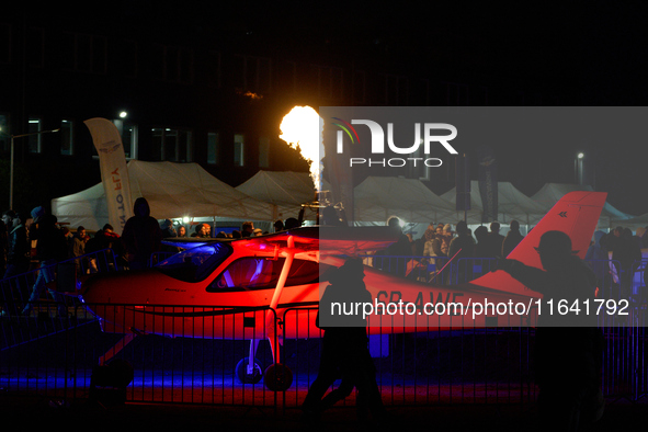 Flames from a hot air balloon burner rise above a parked Tecnam P2008JC MkII at the Warsaw Institute of Aviation in Warsaw, Poland on 04 Oct...