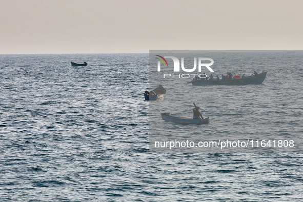 Fishing boats are in the ocean along Paruthiyoor Beach in Paruthiyoor, Kerala, India, on April 15, 2024. 