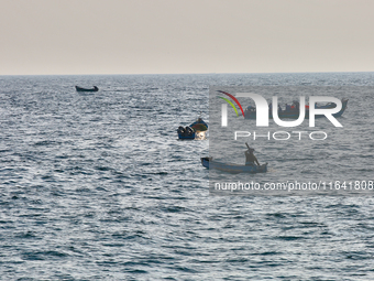 Fishing boats are in the ocean along Paruthiyoor Beach in Paruthiyoor, Kerala, India, on April 15, 2024. (