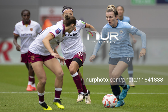 Lauren Hemp #11 of Manchester City W.F.C. is tackled by an opponent during the Barclays FA Women's Super League match between Manchester Cit...