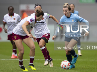 Lauren Hemp #11 of Manchester City W.F.C. is tackled by an opponent during the Barclays FA Women's Super League match between Manchester Cit...