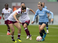 Lauren Hemp #11 of Manchester City W.F.C. is tackled by an opponent during the Barclays FA Women's Super League match between Manchester Cit...