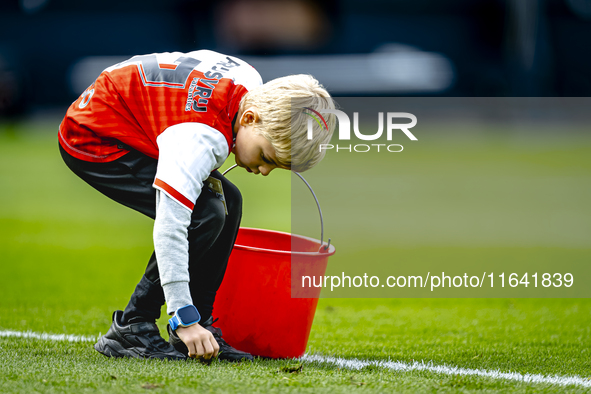 A young grass boy is present during the match between Feyenoord and Twente at the Feyenoord stadium De Kuip for the Dutch Eredivisie season...