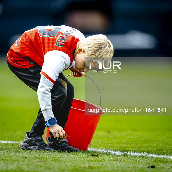 A young grass boy is present during the match between Feyenoord and Twente at the Feyenoord stadium De Kuip for the Dutch Eredivisie season...