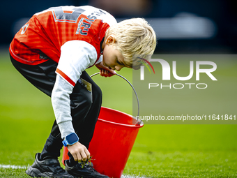 A young grass boy is present during the match between Feyenoord and Twente at the Feyenoord stadium De Kuip for the Dutch Eredivisie season...